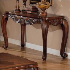 Smooth rounded edges. Carved details. Scrolled legs. Intricate carving with shell and leaf design. Made from wood and veneers. Legs are solid wood with a cherry finish, the top is MDF. 52.5 in. W x 20 in. D x 29 in. H. Warranty This beautiful sofa table with add the perfect finishing touch to your traditional living room ensemble. Elegant scrolled legs support this stunning table. Add this piece to your living room for a warm traditional look that you will love.