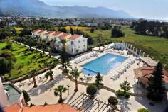 This attractive, award-winning hotel is set in the seaside town of Karaoglanoglou in Northern Cyprus just 15 minutes from Kyrenia. Visitors won't want to miss Kyrenia's historic harbour and Byzantine castle. Alternatively, guests may simply relax in the hotel gardens amidst fruit trees and grape vines, or by the shimmering outdoor pool. The hotel offers both standard rooms and 2-bedroom bungalows, all comfortable and airy with sitting area, refrigerator, air-conditioning, and balcony with mountain or sea views. Guests can enjoy a hearty English breakfast in the hotel restaurant, which serves a la carte breakfast, lunch and dinner with children's menu available. Friendly and cheerful hotel staff are delighted to help guests find the best places for activities including turtle watching, horseback riding and paragliding. A wonderful place for an action-packed family adventure or a relaxing seaside holiday.