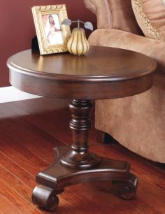Dimensions: 26 diam. x 25H in. Premium wood construction. Dark brown finish. Round top for display. Turned pedestal base. Scrolled foot detail. Gracefully traditional yet timeless, the Signature Design By Ashley Brookfield Brown Round End Table is a true transitional beauty. Scaled large enough to offer practical display space and create visual appeal, this end table is 26 inches around. It stands on a sturdy, well-turned pedestal base that ends in carefully scrolled legs. Built to last, this end table is carved from premium wood and comes in a rich dark brown finish that adds to its classic appeal. About Signature Design By AshleySignature Design By Ashley, Inc. is the largest manufacturer of furniture in the world. Established in 1945, Ashley offers one of the industry's broadest product assortments to retail partners in 123 countries. From design through fulfillment, Ashley continuously strives to provide you, our customer, with the best values, selection and service in the furniture industry.
