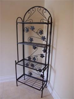 Durable cast iron construction for years of use. High-grade, black polyester powder-coat finish. 4 shelves for display or storage. Strong and durable, even in heavy winds. Relatively lightweight for easy transport. Superior artisanship and intricate details. Electrostatic application ensures a smooth finish. Includes brass and stainless steel hardware. Quick and easy-to-read instructions included. Elegance and lasting function combine to make the Sun Weave Baker's Rack - Black a charming accent for any your garden or home. Intricately designed with scroll and leaf patterns, it features four rectangular shelves to beautifully display vases, potted plants, figurines, or crystal ware. Made of durable cast iron, this baker's rack is strong and durable, even in heavy winds, yet relatively lightweight, making it easy to move. The high-grade black polyester powder-coat finish is designed to maintain its appearance for years to come with minimal maintenance. Designed for years of enjoyment, this lovely baker's rack is sure to attract the admiration of your guests. Comes with brass and stainless steel assembly hardware and assembly instructions. DimensionsOverall: 23W x 13.5D x 62H inches Top 2 shelves: 8L x 21W inches Distance between top 2 shelves: 14 inches Bottom 2 shelves: 11L x 21W inches Distance between bottom 2 shelves: 15 inches About Oakland LivingSpecializing in the creation of top-notch cast aluminum, iron, resin wicker, and stone outdoor furniture and accents, Oakland Living has been in the outdoor-furniture manufacturing business for over 15 years. From garden stones to complete furniture sets, they're renowned for their ability to provide their customers with high-quality pieces at a great price. A 72,000-square-foot distribution center, located in Rochester, MI, houses a supply of their best sellers, making it easy and convenient to ship items quickly to customers across the nation.