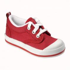 Red Canvas in a classic, authentic style from Keds, an American icon- Rubber outsole with deep flex grooves for flexibility- Rubber toe cap for protection and durability- Padded collar and terrycloth lining for comfort- Lace up closure for a snug fit In 1916, Keds created an American Classic: the first shoe with a soft rubber sole. This original sneaker, called the Champion has remained a style icon for over ninety years. Worn by Audrey Hepburn, Marilyn Monroe and Jackie O, and consistently celebrated by Vogue, Elle and Women's Wear Daily, Keds continues to attract fashion designers, stylists and top editors in the industry. Size