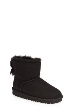UGG AustraliaKids' Mini Bailey Bow Short Boot, Black, 13T-4YDetailsSheepskin suede UGG boot with bow-ribbon on back Dyed shearling section (Australia), 100% UGGpure wool, or mixed shearling and UGGpure wool lining. Whipstitching over piping at upper. 3/4" lugged EVA rubber sole for traction. Wear barefoot to maximize benefits of plush moisture-wicking micro pile lining: keeps bare feet comfy in temperatures as low as -30 degrees Fahrenheit to as high as 80 degrees Fahrenheit. Imported. Sizing Note: Toddler sizes end in "T"; Youth sizes end in "Y". Toddler sizes are smaller than youth sizes. Designer About UGG Australia: When an Australian surfer visited the U.S. in 1978 and brought his home country's sheepskin boots with him, the idea for UGG Australia was born. With comfort and luxury as its two watchwords, UGG Australia soon built a stellar reputation in both categories. Beyond the well-known sheepskin boots spotted on a who's who-list of Hollywood stars, UGG Australia also features styles such as knit boots, shearling slippers, and leather hiking boots for men and women. Plus, there's a children's collection with wee sheepskin boots and even Mary Jane-style walking shoes.