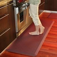 The Trellis by WellnessMats is a premier anti-fatigue mat. This revolutionary floor mat is ergonomically engineered and medically proven to provide unsurpassed comfort, safety, relief and well-being while you stand. WellnessMats are the perfect kitchen, vanity, laundry and even garage mat. Proudly made in the USA, WellnessMats continue to be proven effective and virtually indestructible in the toughest commercial environments. WellnessMats are the mat of choice for world-renowned chefs and are found in professional and residential kitchens, hotels, airports, spas and retailers all over the world. WellnessMats' unique one-piece construction from a proprietary formulation of 0.75-inch thick, 100-percent polyurethane is the gold standard for anti-fatigue mats. Color/pattern: Trellis burgundy Exceptional comfort Resistant to punctures, tears, abrasions, stains, slips and wear Safe and non-toxic, PVC and BPA-free (so no noxious smells or off-gassing) Will always lie flat, never delaminate or curl up at the edges, never compress or wear through Easy care: Simply wipe clean with a damp cloth or sponge, use any common household cleaner or sweep clean of dirt and dust Materials: 100-percent polyurethane Dimensions: 72 inches long x 24 inches wide x 0.75 inch thick Model: MT62WMRBUR The digital images we display have the most accurate color possible. However, due to differences in computer monitors, we cannot be responsible for variations in color between the actual product and your screen.