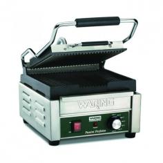 Warings Panini Sandwich Grill the Italian Perfetto WPG150B is a compact electric grill toaster with ribbed cast iron plates that produce sandwiches of warm, melty goodness with beautifully browned bread. The WPG150B Sandwich Grill has a 9-1/4 x 9-3/4 cooking surface. The top plate is hinged and is lifted up and down with a heat-resistant handle. The Panini Grill accommodates foods up to three inches thick thanks to the auto-balancing upper plate, so you can grill up sandwiches stuffed with fillings. This Sandwich Grill is designed to handle heavy commercial use and features a durable brushed stainless steel body and removable drip tray for easy clean up.