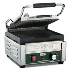 Warings Panini Sandwich Grill the Italian Perfetto WPG150 is a compact electric grill toaster with ribbed cast iron plates that produce sandwiches of warm, melty goodness with beautifully browned bread. The WPG150 Sandwich Grill has a 9-1/4 x 9-3/4 cooking surface. The top plate is hinged and is lifted up and down with a heat-resistant handle. The Panini Grill accommodates foods up to three inches thick thanks to the auto-balancing upper plate, so you can grill up sandwiches stuffed with fillings. This Sandwich Grill is designed to handle heavy commercial use and features a durable brushed stainless steel body and removable drip tray for easy clean up.