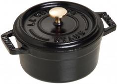 Dutch Ovens - The culinary advantage to gourmet cooking! This enameled cast-iron 3/4-qt. Staub Round Cocotte presents a unique self-basting system for flavorful, nutrient-rich, professionally-cooked entrees. Handcrafted in France, Staub black enameled cast-iron cookware is preferred by internationally-famous chefs for its superb heat distribution and retention. This small round Dutch oven hides its secret under the lid: spikes collect condensation and release, creating a rain forest effect to continuously shower juices over food. Staub's signature matte black enameled cast-iron cocotte interior is a superior cooking environment for nonstick braising and caramelizing, and easy release. The Staub round cocotte is cast in a single-use mold, high-fired at 1,400 F and adding 2-3 coats of enamel inside and out. Suitable for all cooktops, the small round Dutch oven with stainless-steel ovenproof knob resists scratches and will not chip, discolor or rust. Seasons naturally with use, without maintenance. Ove - Specifications Model: 1101425 Materials: enameled cast-iron 5 1/2" Dia. (7 1/4"W w/handles) x 3"H (4 1/2" w/lid) Base: 4 1/4" Dia. Weight: 3-lb, 4-oz. Made in France Care and Use Dishwasher-safe, but hand washing recommended Before first use, wash with warm water and dishwashing liquid, then dry. Add a small amount of cooking oil into pot before using to enhance the properties of the special black enamel surface Oven-safe to 500 F and broiler-safe Suitable for gas, electric, glass, halogen and induction cooktops