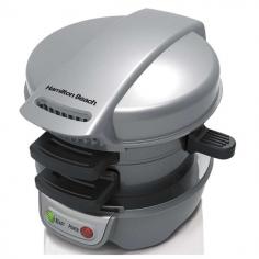 Hamilton Beach Breakfast Sandwich Maker. Forget the fast food drive-through. With the Hamilton Beach Breakfast Sandwich Maker, you can enjoy a hot, homemade breakfast sandwich in under 5 minutes. Simply place the ingredients inside, build the base of your sandwich in the bottom layer, place the egg on the cooking plate and close the lid. Slide the cooking plate out and your sandwich assembles itself. Open the lid and your hot breakfast sandwich is ready to eat. The included recipe book provides a variety of breakfast sandwich options, from the traditional egg, ham and cheese to the unique cheddar, apple, bacon and egg croissant sandwich. Breakfast Made Easy (and Delicious) How to Use Once preheated, place the bottom half of your bread choice onto the bottom plate and top it with ingredients such as precooked meats, cheese and vegetables. Then, lower the top ring and cooking plate. Crack an egg onto the cooking plate and pierce the yolk. Place the other half of your bread selection on top of the egg and close the cover. After 5 minutes, rotate the cooking plate handle clockwise until it stops. Using an oven mitt, lift the ring assembly and cover via the bottom handle and voilà, your breakfast sandwich is complete. Simply remove the sandwich with a plastic or wooden utensil and enjoy! Metal, Plastic, Made in USA Ready in 5 minutes, cook delicious breakfast sandwiches in the comfort of your own home Use your own fresh ingredients, including eggs, cheese and much more Make sandwiches with English muffins, biscuits, small bagels, and more All removable parts are dishwasher safe; surfaces are covered with durable, nonstick coating Quick and easy recipes included We are an authorized Hamilton Beach Dealer New Hamilton Beach 25475 Breakfast Sand which Maker - Gray Make a hot and hearty breakfast sandwich at home Quick and easy and recipes are included Ready to eat in 5 minutes or less Use your own fresh ingredients, including eggs, cheese & precooked meat* Cooks every layer of your breakfast sandwich to perfection Cooking plate cooks a fresh egg perfectly, then slides out to assemble your sandwich Make sandwiches with English muffins, biscuits, small bagels, and more Make delicious restaurant quality sandwiches in the comfort of your own home All removable parts are dishwasher safe Surfaces are covered with durable, nonstick coating Product Dimensions: 6.8 x 6.9 x 8.8 inches Weight: 3.25 Lbs Product Condition: Brand New Part # 25475 Warranty 2 years (One year manufacturer warranty + one year VMInnovations warranty)