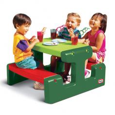 Why we love this picnic table: One-piece activity and dining table Seats up to four kids aged 18 months and up Classic, evergreen colours ideal for gardens Wipe-clean surfaces Can be used inside or outdoors Rounded edges for safety Tots can dine al fresco with the Little Tikes Junior Picnic Table in Green. Measuring 47cm high, 72cm long and 84cm wide, this chunky table has space to seat up to four children aged 18 months and up. It's ideal for colouring-in or playing games and its handy wipe-clean surface means it's also great for messy eaters and youngsters who like painting. Little ones will love having their very own activity and dining space, while mum and dad will approve of the rounded safety edges that prevent knocks and bumps. Made from durable, weather-proof plastic, the Little Tikes Junior Picnic Table is built to last and can be used indoors or outside. Don't ruin the surprise! Please be aware that Little Tikes toys are delivered in a box with a picture of the toy on the outside.