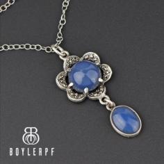 Beautiful feminine Edwardian pendant necklace with ethereal lavender-blue chalcedony set in a sterling silver and chalcedony drop swaying below. Hailing from the turn of the last century, circa 1900s, the stone has sparkling marcasite set into the floral pendant. A fine sterling chain completes the piece. 