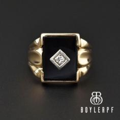 Handsome and distinctive1920s Art Deco era ring evocative of Victorian mourning jewelry. A rectangle black onyx gemstone set in a heavy 10K yellow gold is pierced dead center by a sparkling .15 carat European-cut diamond in a white gold diamond-shaped bezel. The thick geometric designed shoulders give way to a smooth back band. A superb ring for either the gents or ladies, great for stacking or those looking for a truly authentic classic!