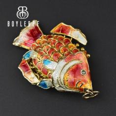 Beautiful large vintage Chinese sunfish pendant with rich enamel scales and fins. Set in gold gilded sterling silver, the fish has a wide thick articulated body and large fins and tail. Enamel colors of orange, yellow, red, and white. The fish symbolizes good luck, abundance, and perseverance.