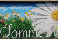 A hidden exterior mural painted on the rooftop of the spray can Montana Factory, Germany. The title of the painting is “Four Seasons”. From left to right the seasons in sequential order are blended onto the one wall. From a variety of references, each represents the seasons in Germany. From snow covered winter to cherry blossom spring. The idea behind this exterior mural wall was to capture some bright and flavoursome colours visible from the head office space in the factory. 