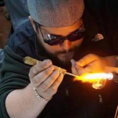 Andrew Origlio is a specialist in blowing glass art. Specializing in melted glass- marbles, mini vases, ornaments, pendants, and pins