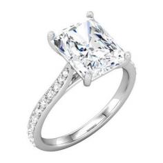This bridal engagement ring features a radiant cut diamond center stone crafted in 14K white gold with channel set diamonds.