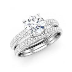 This stunning bridal set features round diamond with surrounded stones in band crafted in 14K white gold. 