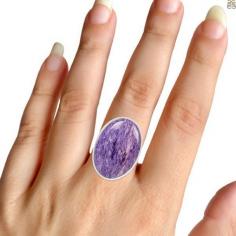 Genuine Charoite Ring : Known As Lilac Stone

Charoite, popularly known as the lilac stone, is a rarely found hydrogen-rich silicate mineral consisting of potassium, barium, calcium strontium, and sodium. The trade name of this stone is charoite jade. It was named in 1978. Its name is derived from the Russian word “chary,” which means magic or charms. When it was first discovered, it was believed to be a fake gem dyed purple to give it a striking appearance. It is mined only in Siberia, Russia. Charoite’s color ranges from translucent lavender to purple, possessing a pearly luster. Due to its unusual swirling, fibrous appearance and intense color, most people think that charoite is a synthetic or artificially enhanced gemstone – it is not. The inclusions of this gemstone are mainly due to the swirly patterns of the mineral.
