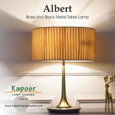 Brighten up your space with the exquisite charm of the Albert Brass And Black Metal Table Lamp! Featuring a sleek brass and black metal base topped with a classic white cotton shade, this lamp adds a touch of sophistication to any room. Elevate your ambiance with Albert!