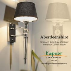 Aberdeenshire Glass and Shiny Brass Wall Light with Black Cotton Shade is a sophisticated and elegant lighting solution. It is designed with a blend of classic and modern elements, featuring a glass and shiny brass construction and a black cotton shade. This product is ideal for those seeking a stylish and high-quality wall light for their home or office. 