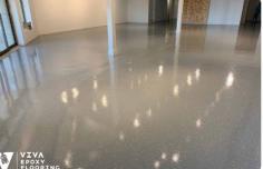 Epoxy flooring refers to a visually appealing floor featuring multiple epoxy resin layers. The technique creates a seamless & glossy floor, enhancing aesthetics & durability. Epoxy flooring tech is typical in various flooring settings for its resistance to wear, chemicals, and stains. It balances elegance and practicality in residential garages, commercial showrooms, and industrial facilities.