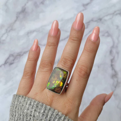 Discover the vibrant spectrum of the colors in a rainbow in Sagacia's Statement Ammolite Rings. These dazzling jewelry pieces, made using 100% natural and genuine ammolite and set in pure 925 sterling silver that is also hypoallergenic in nature, showcase an array of brilliant hues that tend to change and shift with every movement. The ammolite gemstone is well-known among Meditation and Mindfulness Practitioners for its connection to ancient wisdom and this gemstone is a stone that brings prosperity, transformation, and positivity to the wearer. Handcrafted with care and precision, our Statement Ammolite Ring automatically makes a bold impression, drawing admiration from the audience. We recommend that you wear this ring when you wish to add a tinge of elegance and mystery to your outfit. So, purchase the Sagacia Statement Ammolite Ring and let this radiant beauty remind you of the endless possibilities that life offers.