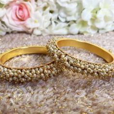 One such element is the traditional Bridal Chura uk, a set of red and white bangles worn by brides in Punjabi weddings.
