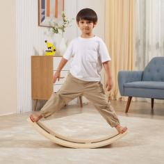 The wooden balancing board is a versatile and interactive toy that offers a wide range of play possibilities and developmental benefits. It is designed as a curved board made of sturdy wood, providing a stable surface for children to explore their balance and coordination skills.One of the key features of the balancing.