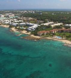 Discover the coastal lifestyle and property opportunities of George Town, Grand Cayman. This aerial view showcases the scenic coastline and surrounding residential communities, highlighting the desirable setting of George Town real estate. Explore homes, condos, villas, townhouses, and land for sale through Crighton Properties.